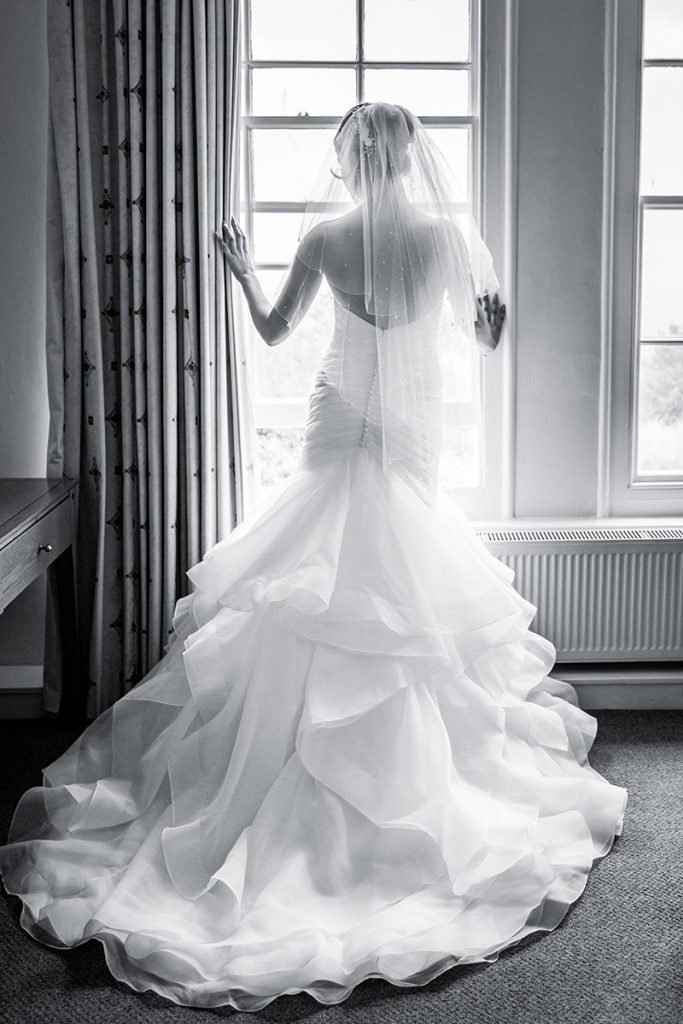 Bride looking out the window taken at Tregenna Castle Cornwall by Cornwall Wedding Photographer Alchemy Photography