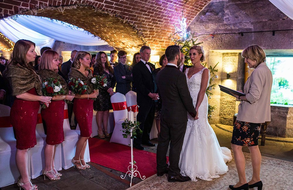 Bride and groom during the wedding ceremony at Polhawn Fort Cornwall