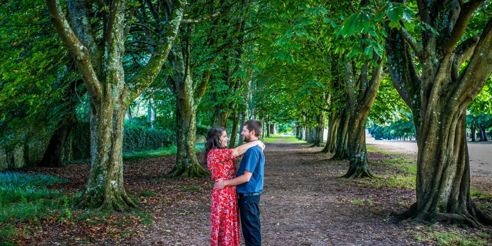 couple embracing in the woods at Mt Edgcumbe Park