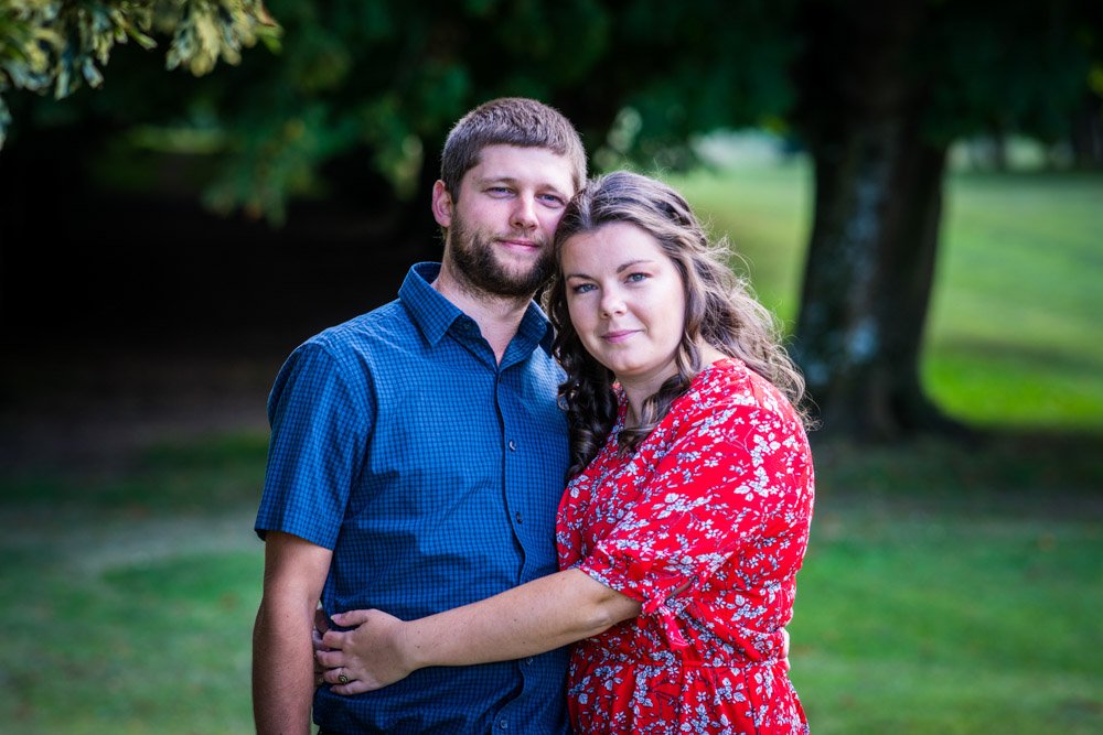 couple iembracing n the woods at Mt Edgcumbe Park