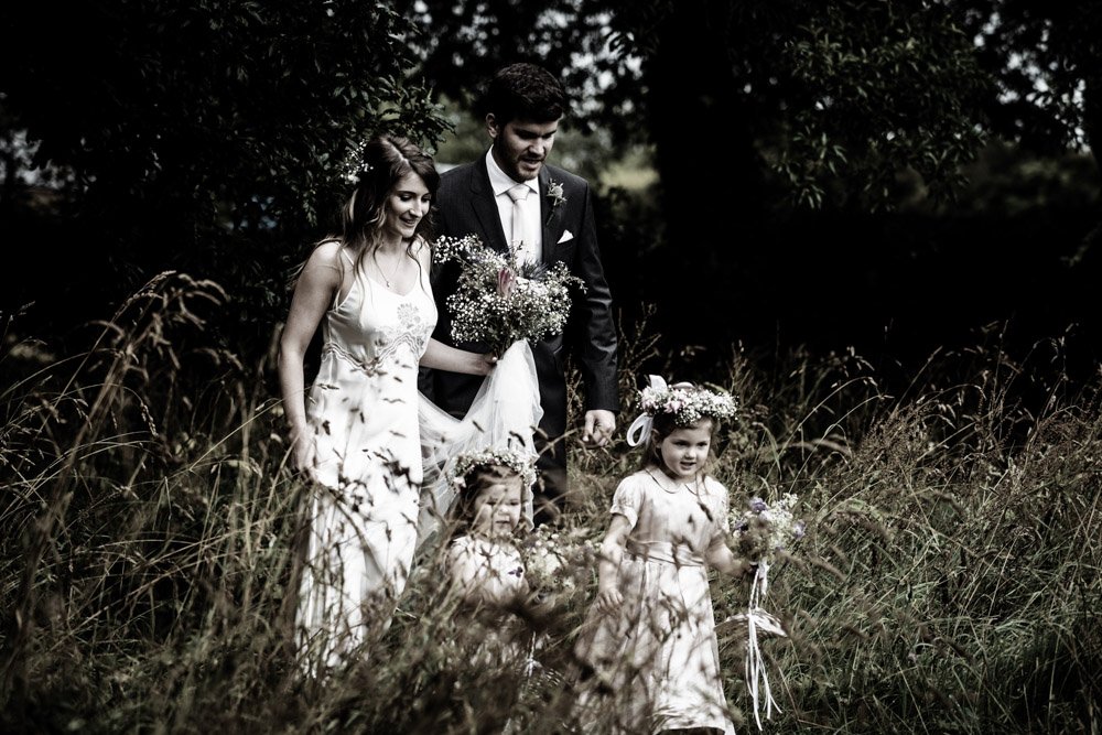 bride, groom and flower girls in the gardens B&W