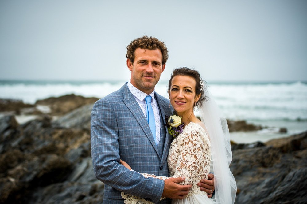 bride and groom embrace at the beach