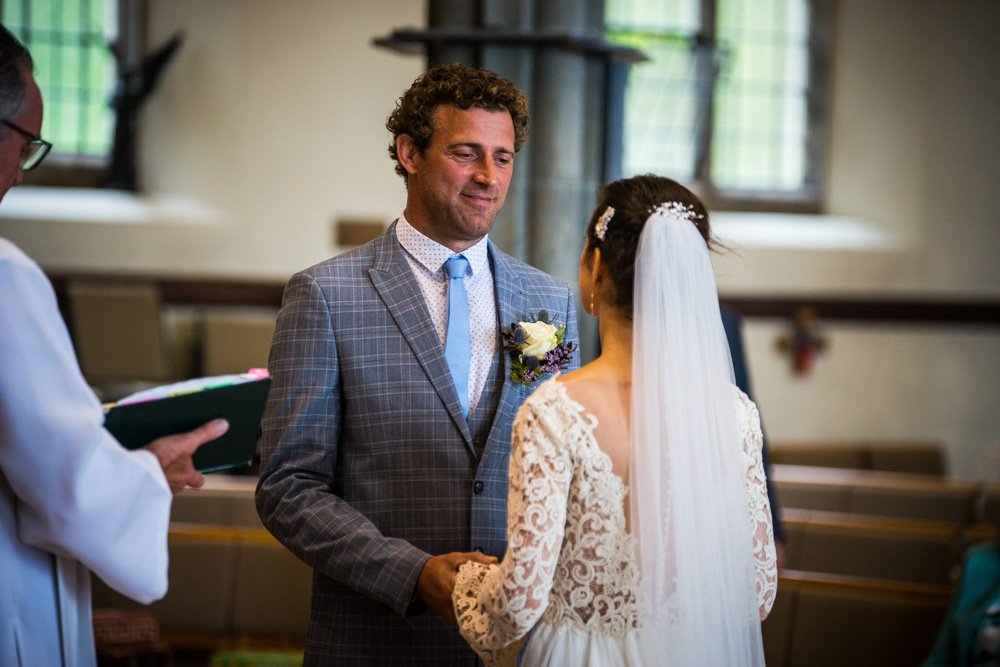 bride and groom during the wedding vows in church