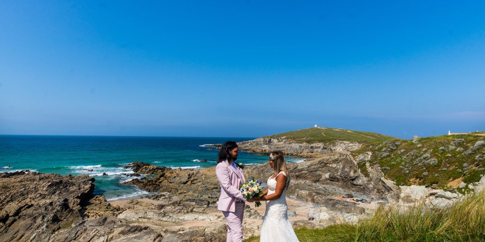 bride and groom on the coastpath in Newquay cornwall