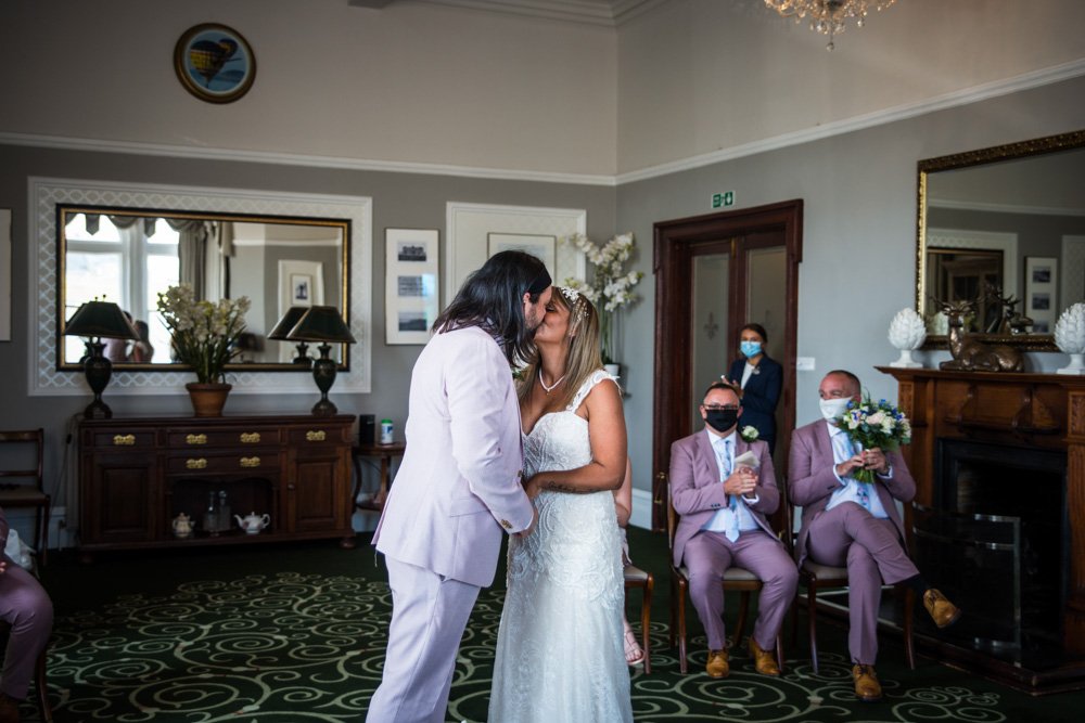 bride and groom first kiss at the wedding ceremony