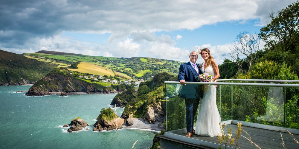 bride and groom with coastal view