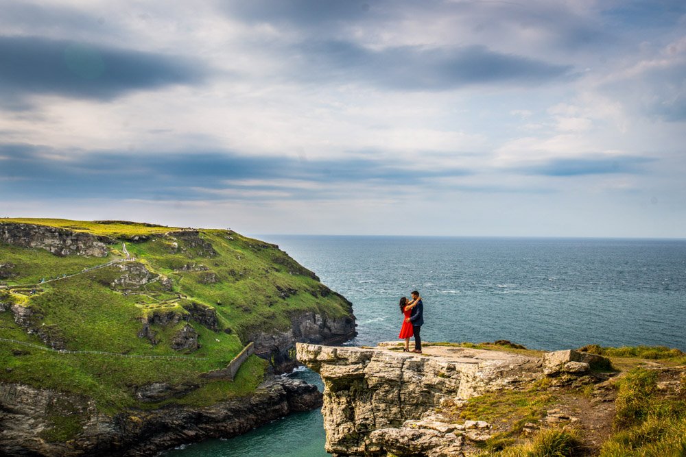 wedding proposal on a rock overlooking Tintagel castle cornwall