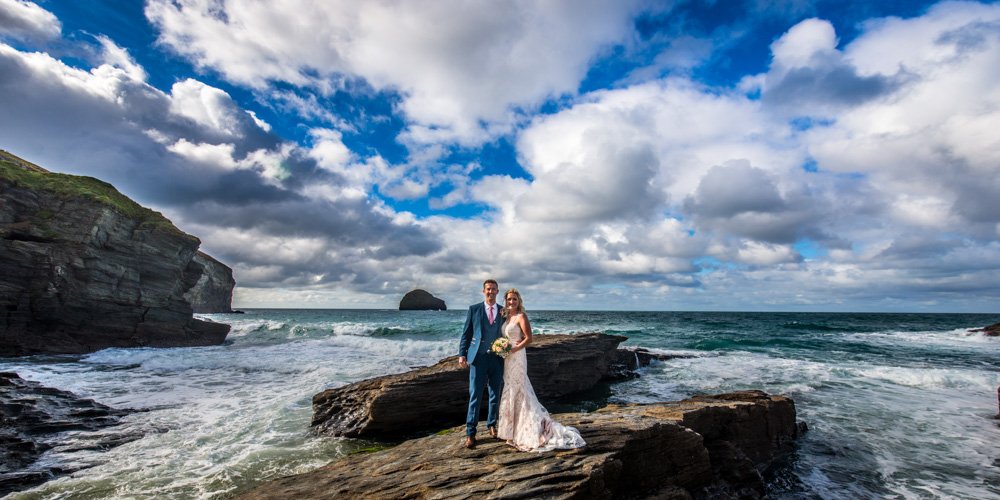 bride and groom at the sea on the rocks at Trebarwith Cornwall