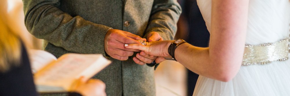 bride and groom exchanging rings