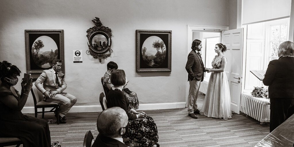 Bride and groom during wedding ceremony at Cockington Park Devon registry office B&W