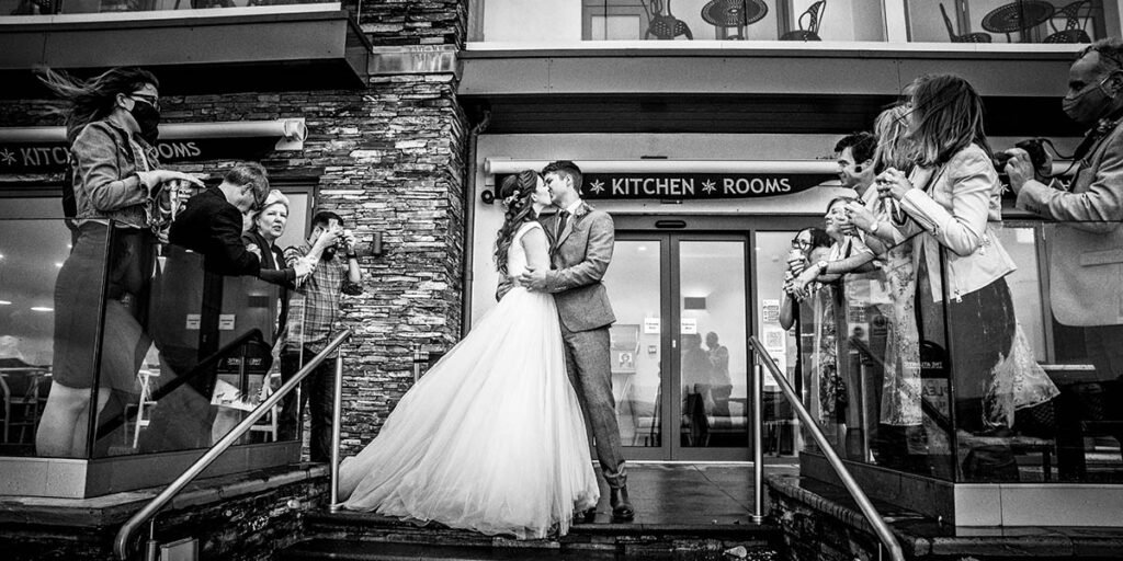 bride and groom kissing on the steps at The Atlantic Bar Polzeath