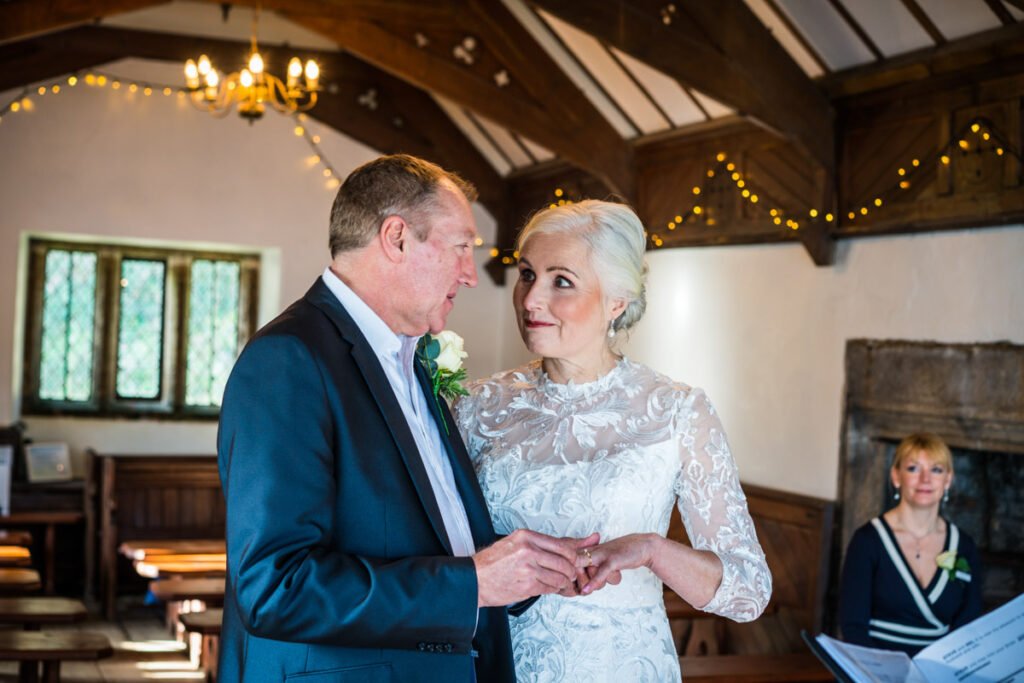 bride and groom exchanging rings at Pentillie Castle Cornwall