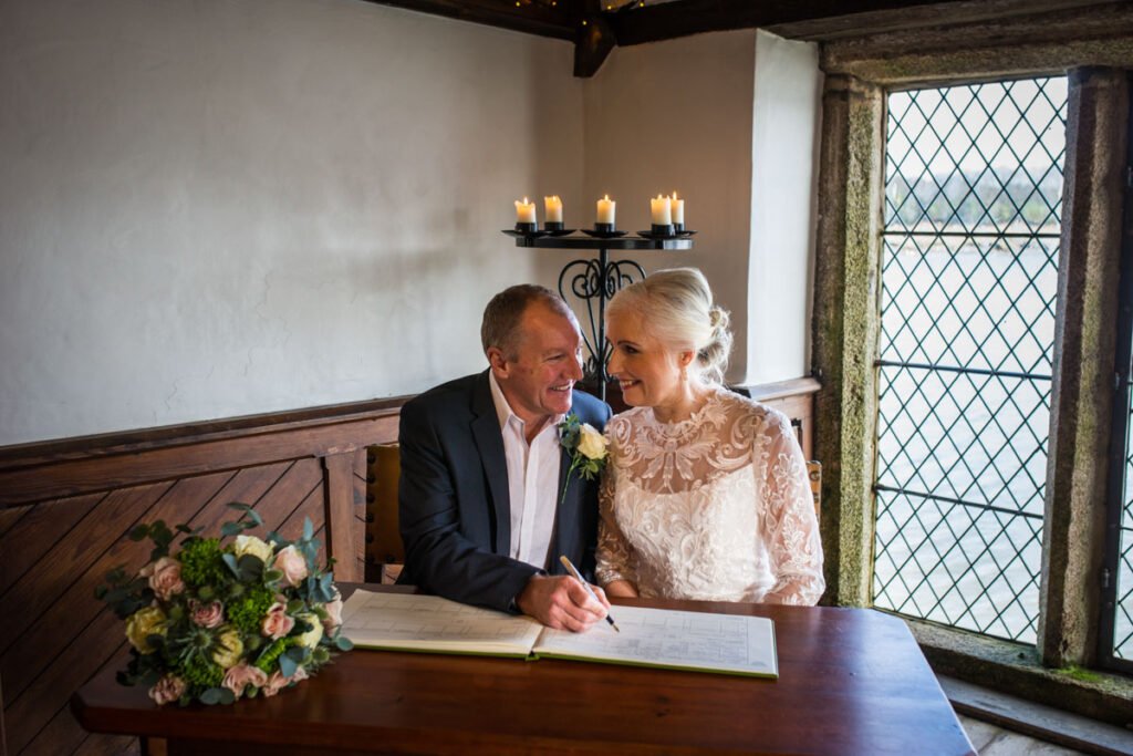 bride and groom signing the register