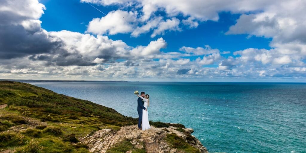 Bride and groom on the coastpath at Tintagel Cornwall