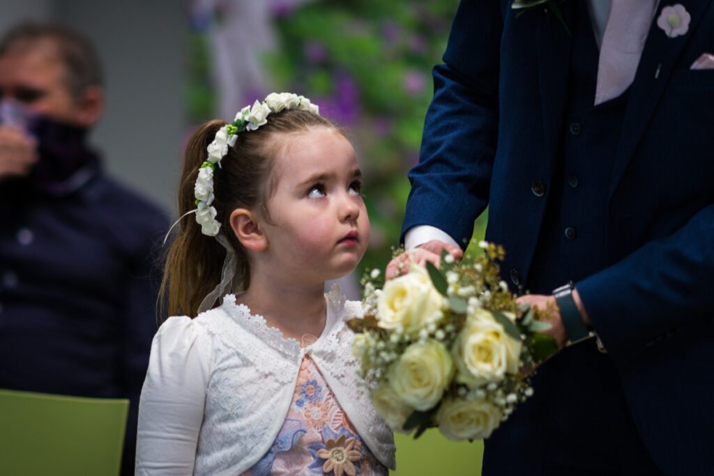 flower girl with brides bouquet