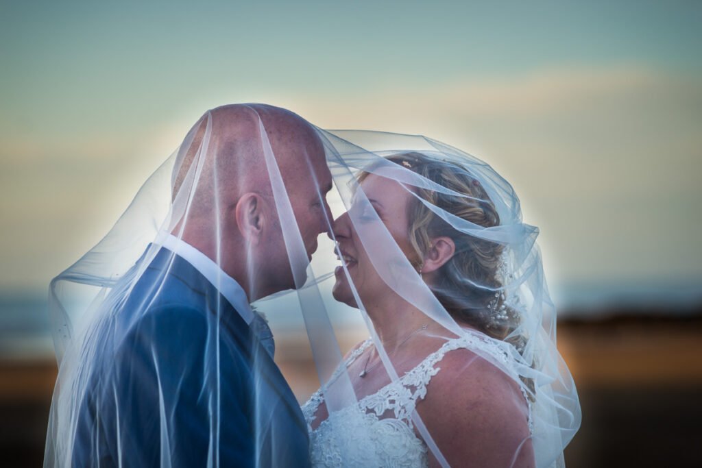 bride and groom veil shot