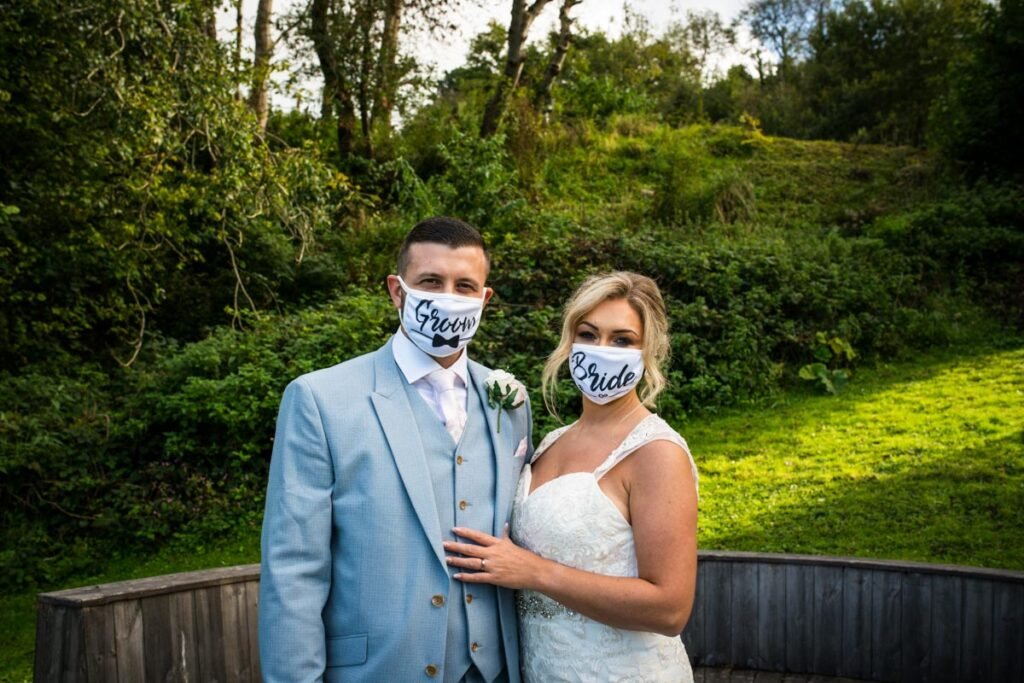 Bride and groom wearing covid 19 masks at The Sandy Cove Hotel Devon