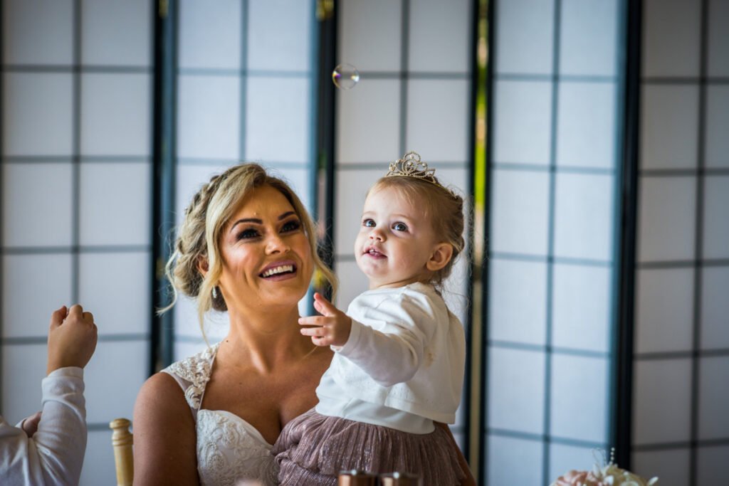 bride and daughter with bubbles