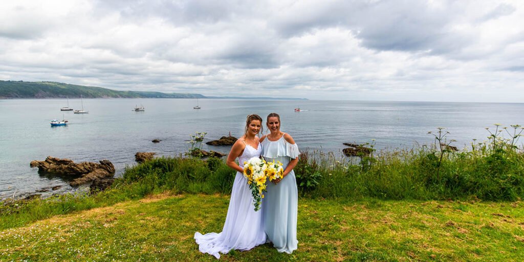 Bride and sister on the beach at Hannafore Point in Looe Cornwall