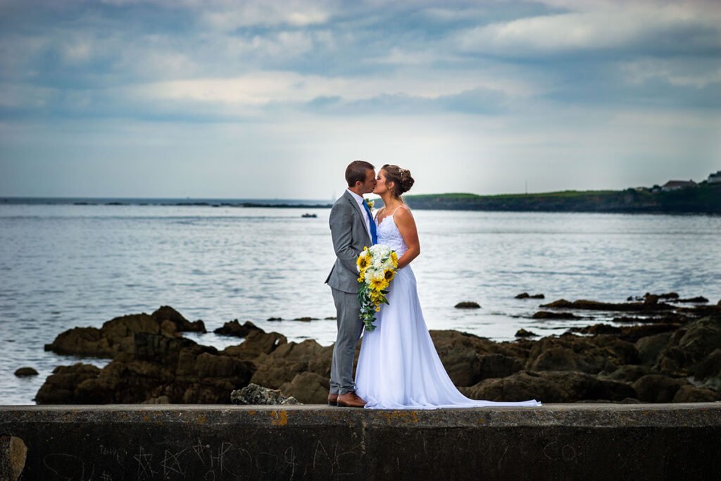 Bride and groom kissing on the beach at Hannafore Point in Looe Cornwall