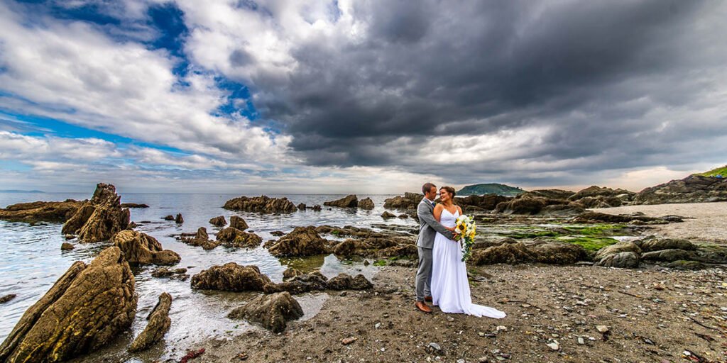 Bride and groom on the beach at Hannafore Point in Looe Cornwall