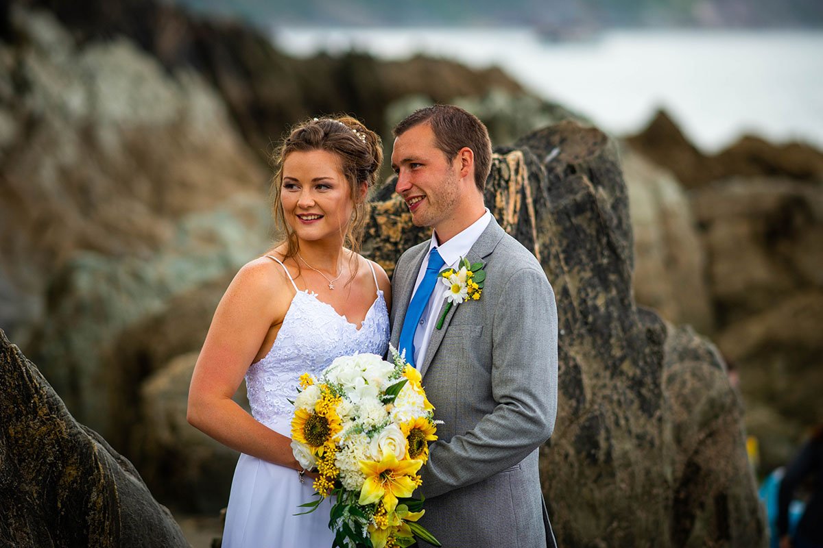 Bride and groom on the beach at Hannafore Point in Looe Cornwall