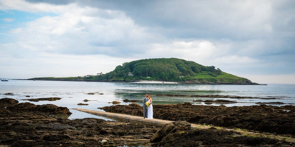 Bride and groom on the beach at Hannafore Point in Looe Cornwall