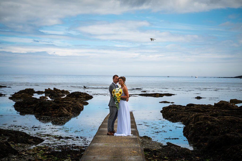 Bride and groom on the beach at Hannafore Point in Looe Cornwall