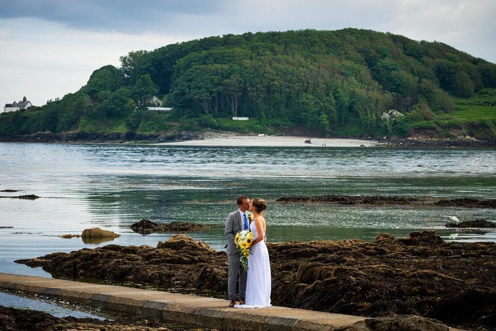 Bride and groom on the beach at Hannafore Point in Looe Cornwall