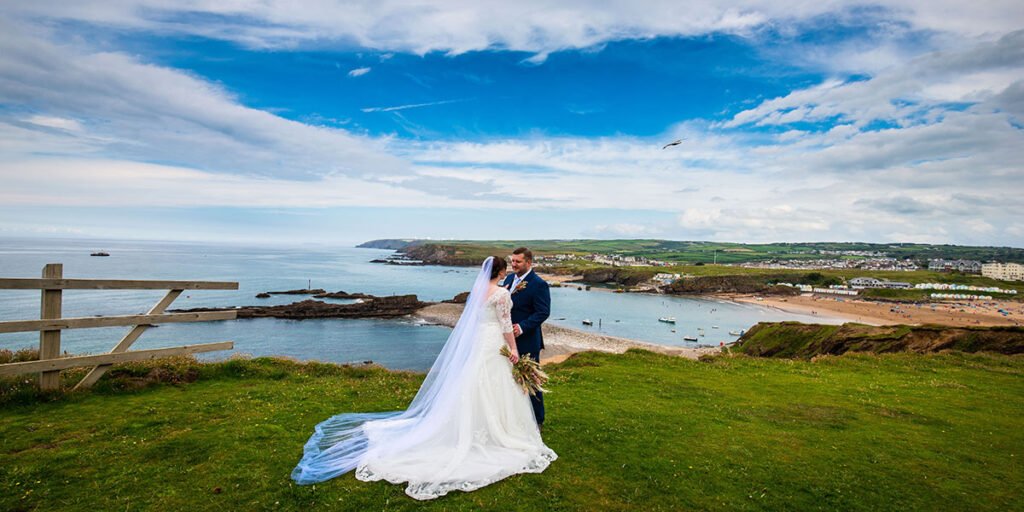 bride and groom on the coastpath overlooking Bude Cornwall