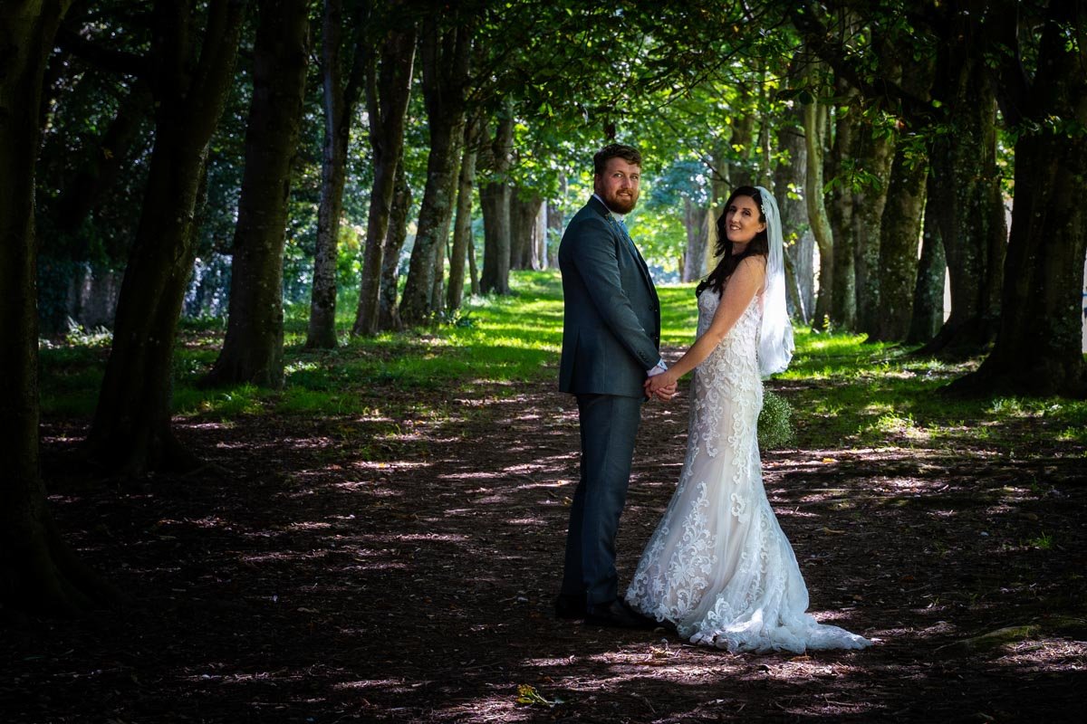 bride and groom in the woods at Mount Edgcumbe Park Cornwall