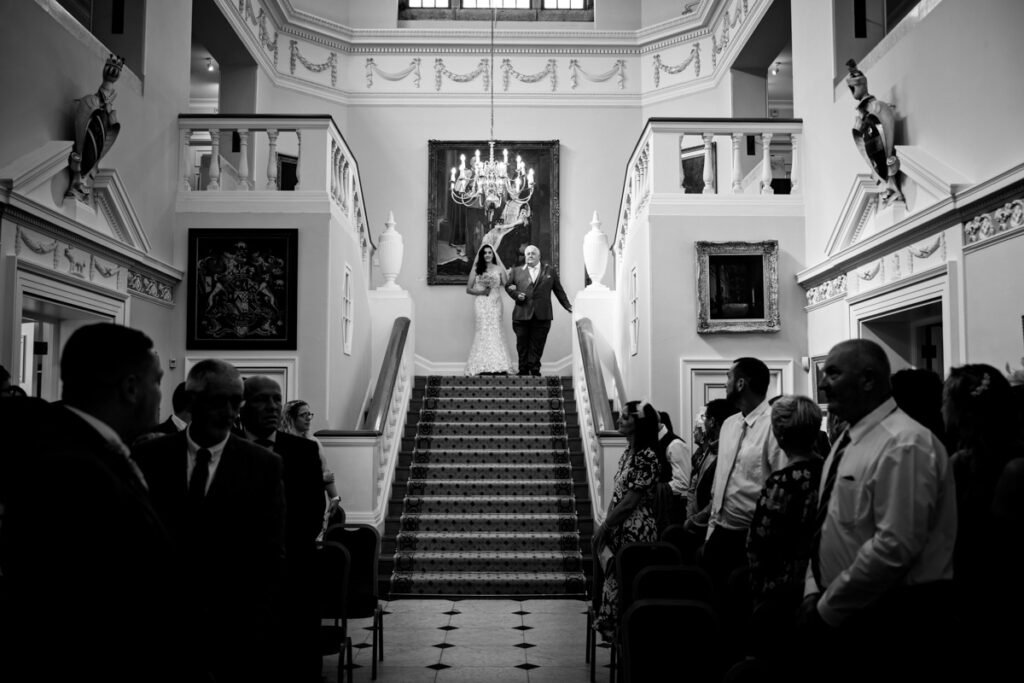 bride coming down the aisle at Mount Edgcumbe Park Cornwall B&W