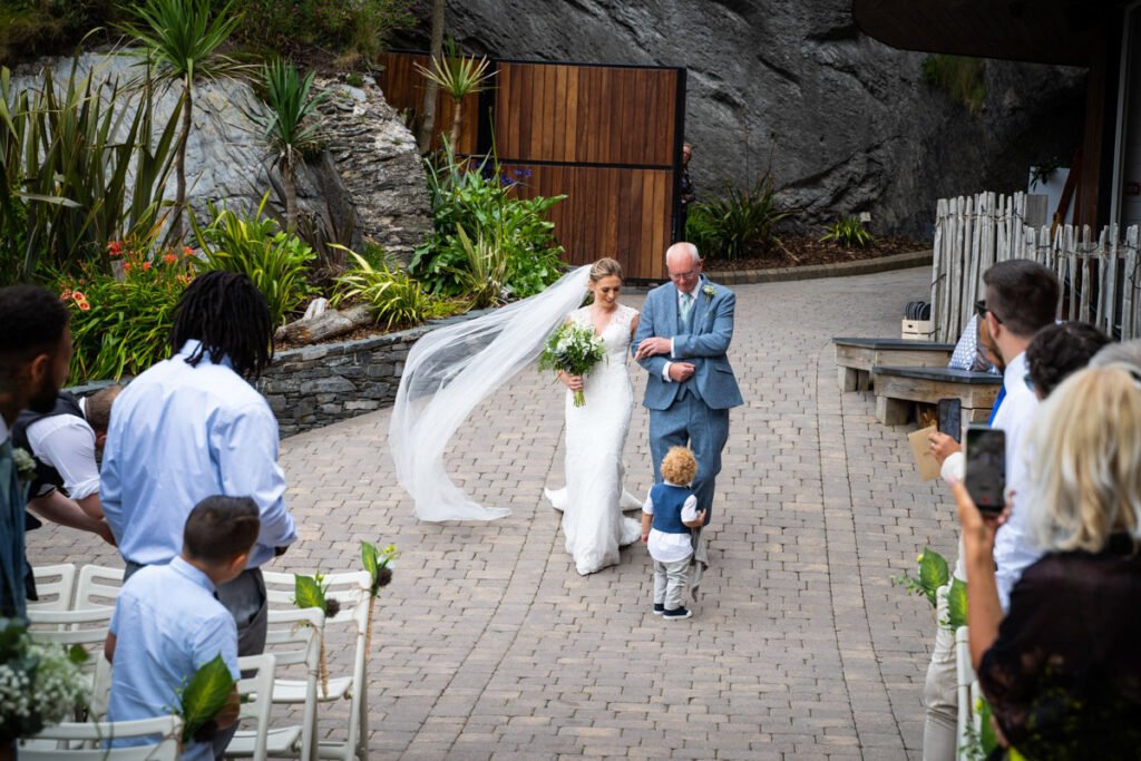 Bride coming down the aisle at Tunnels beaches Ilfracombe Devon