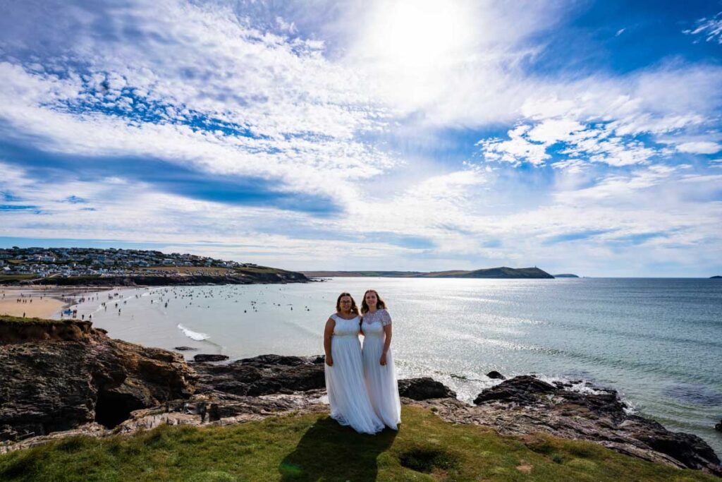 bride and bride on the coast path at Polzeath beach Cornwall