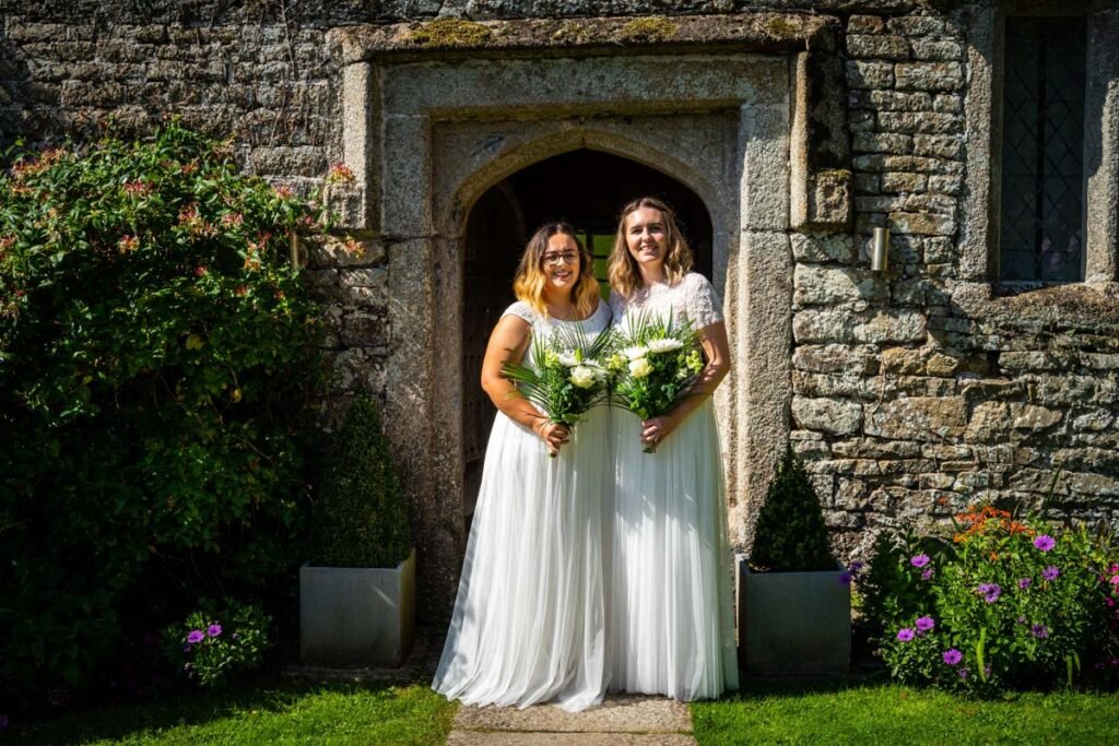 bride and bride in the doorway at Pengenna Manor Cornwall