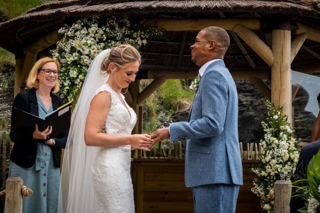 bride and groom exchanging rings at Tunnels beaches Ilfracombe Devon