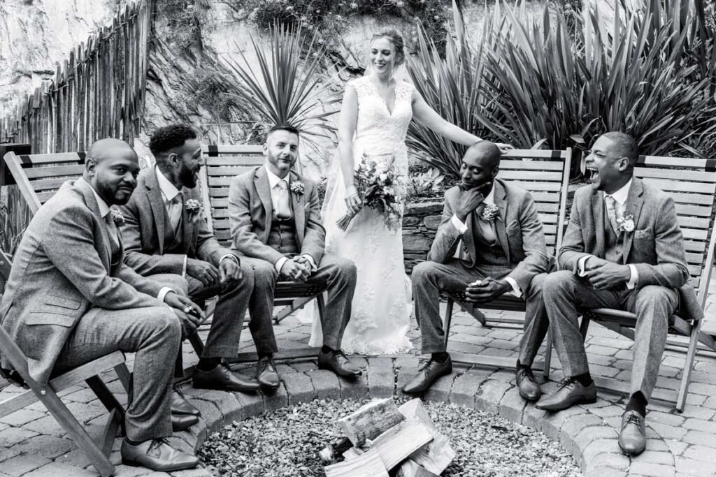 bride and groomsmen at Tunnels beaches Ilfracombe Devon B&W