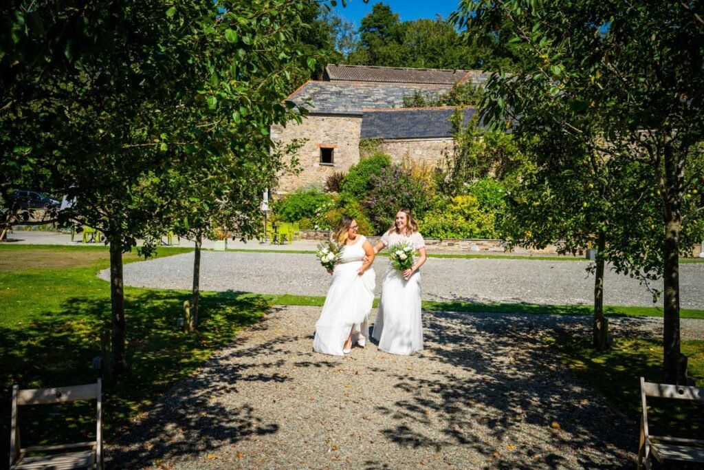 bride and bride arriving at the ceremony at Pengenna Manor Cornwall