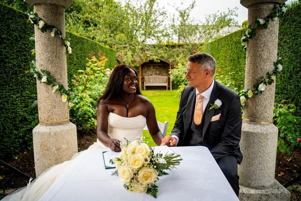 bride and groom signing the register at glebe farm cottages devon wedding venue