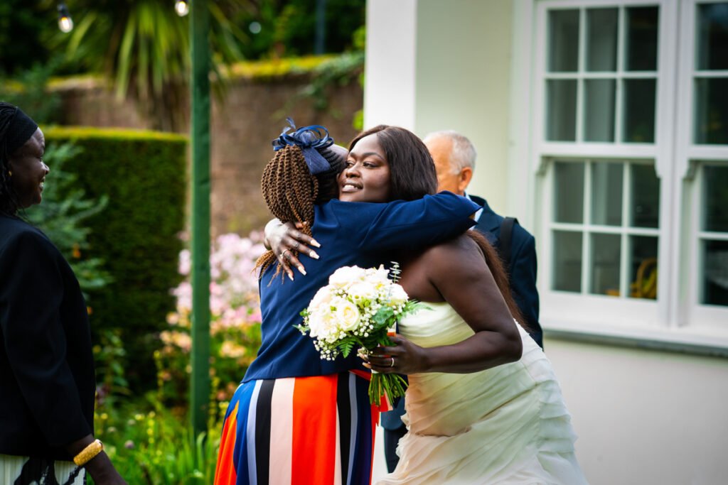 bride and mum embrace at glebe farm cottages devon wedding venue