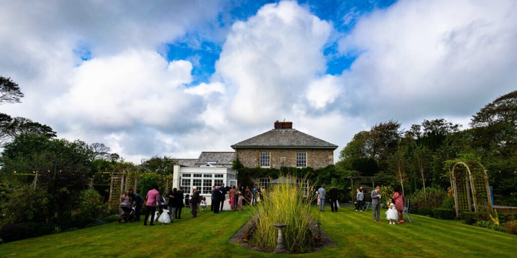 guests in the gardens at glebe farm cottages devon wedding venue