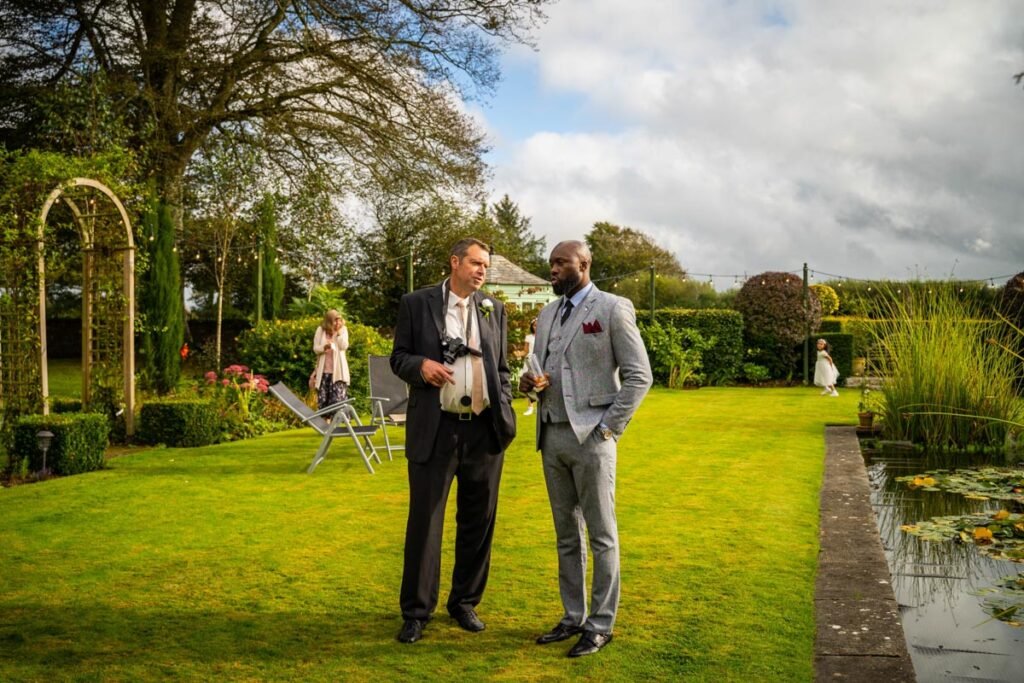 guests in the gardens at glebe farm cottages devon wedding venue