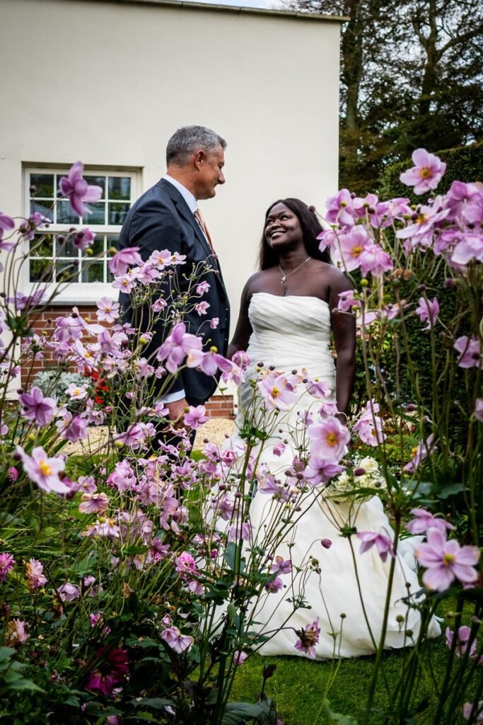 bride and groom in the gardens at glebe farm cottages devon wedding venue