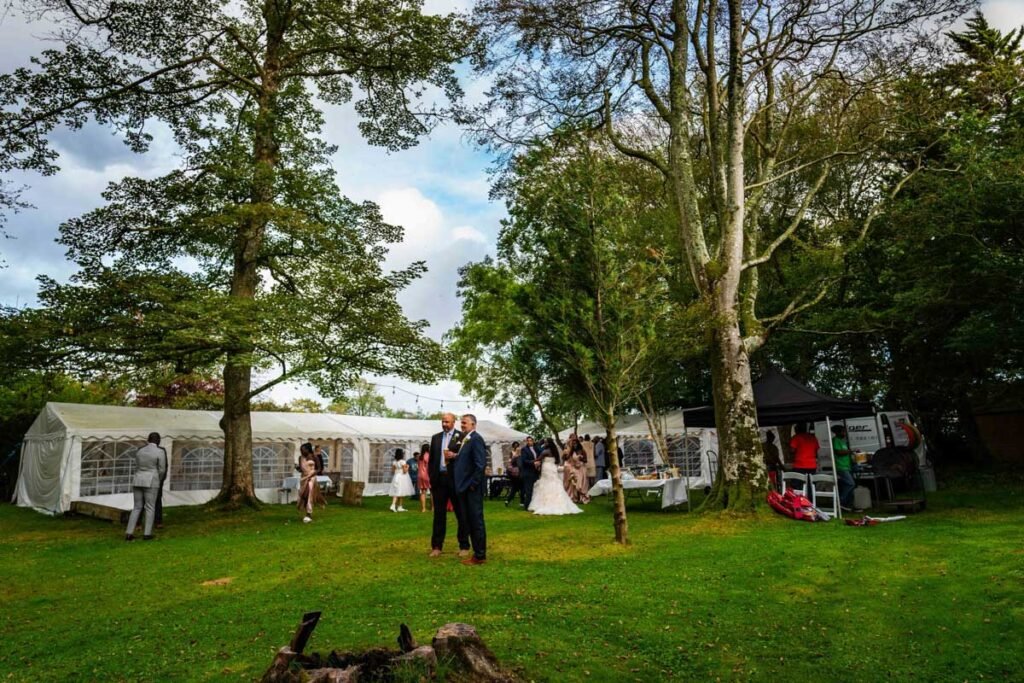 guests in the garden at glebe farm cottages devon wedding venue