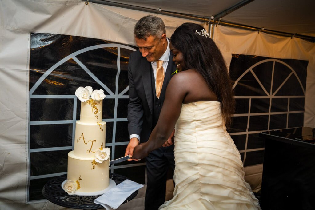 bride and groom cake cutting at glebe farm cottages wedding venue devon