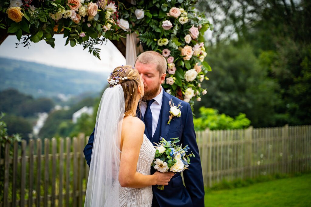 bride and groom kissing at devon wedding venue The Sandy cove hotel