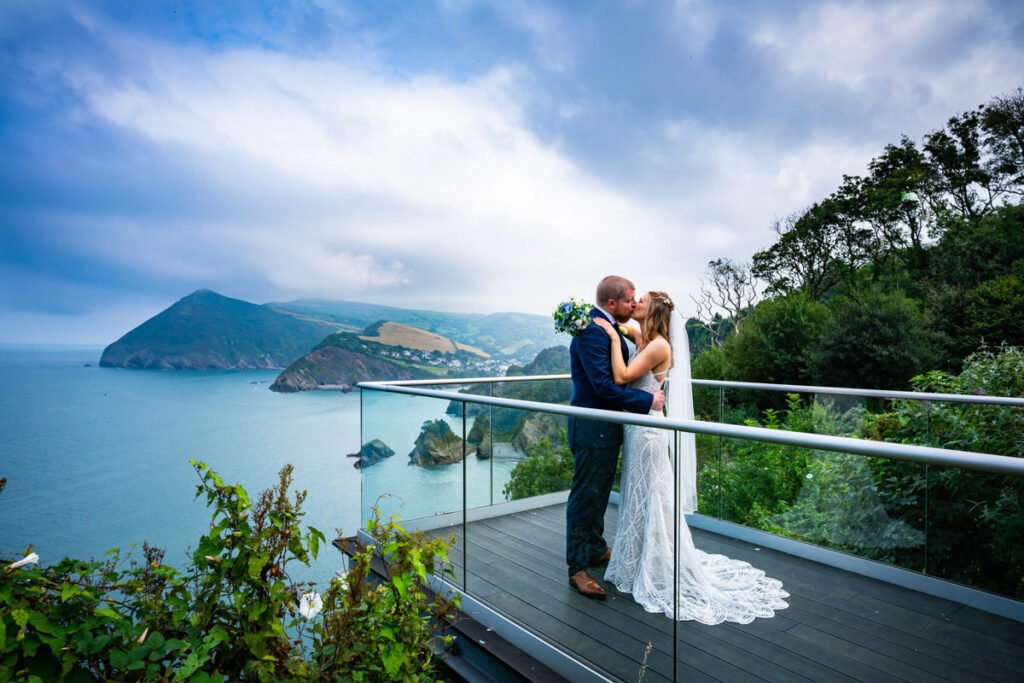 bride and groom kissing overlooking the sea at devon wedding venue The Sandy cove hotel