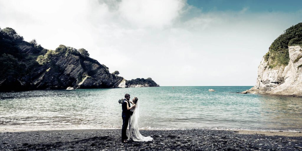 bride and groom on the beach at devon wedding venue The Sandy cove hotel