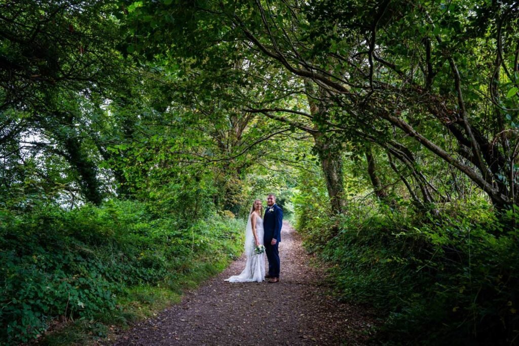 bride and groom in the woods at devon wedding venue The Sandy cove hotel