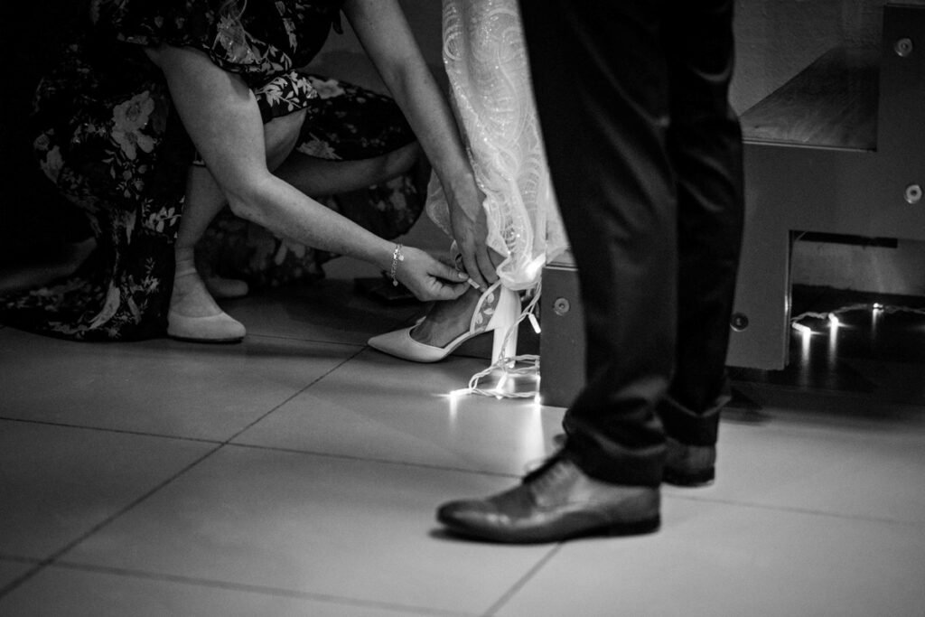 brides shoes being tied at Trevenna Barns Cornwall